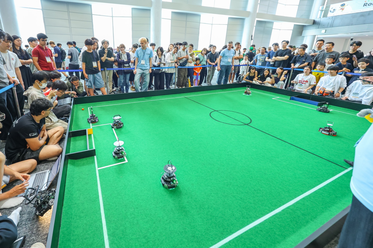 RoboCupJunior soccer at RoboCup 2026 — Junior teams fielding a combined “superteam,” the same idea behind a Small Size League squad.